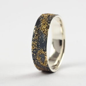 Gold Chaos - 6 mm. The ring is made from sterling silver, slightly textured with reticulation and oxidized. Gold spots are solid 18kt gold. It is random mix of gold dust, microgranules and solder fused to silver surface.