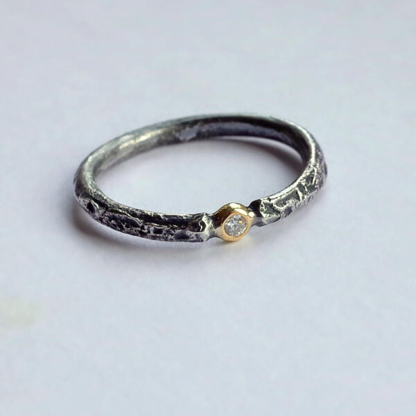 Rustic Diamond 18k Yellow Gold: Sterling silver band textured with reticulation (melting of the surface), round and comfortable, 2mm wide. Gemstone setting is made from 18k Yellow gold. Diamond is 1.5 mm, SI quality, near colorless (G/H) and conflict free. Set in neat gold ball.