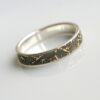 Gold Chaos - 4 mm. The ring is made from sterling silver, slightly textured with reticulation and oxidized. Gold spots are solid 18kt gold. It is random mix of gold dust, microgranules and solder fused to silver surface.