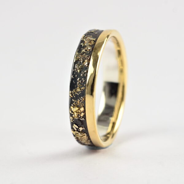 Gold Chaos with Gold Edge: The ring is made from sterling silver, slightly textured with reticulation and oxidized. Gold spots are solid 18kt gold. It is random mix of gold dust, microgranules and solder fused to silver surface. The edge is solid 18k gold.