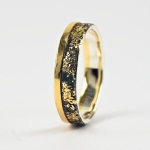 Gold Chaos with Gold Edge: The ring is made from sterling silver, slightly textured with reticulation and oxidized. Gold spots are solid 18kt gold. It is random mix of gold dust, microgranules and solder fused to silver surface. The edge is solid 18k gold.