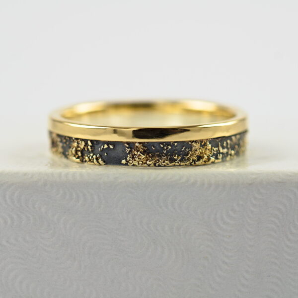 Gold Chaos with Gold Edge: The ring is made from sterling silver, slightly textured with reticulation and oxidized. Gold spots are solid 18kt gold. It is random mix of gold dust, microgranules and solder fused to silver surface. The edge is solid 18k gold.