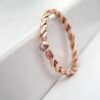 Dainty White Sapphire Rose Gold Ring: Simple, elegant, comfortable to wear and affordable ring made from twisted rose gold wire. Gemstone is high quality white sapphire, 1.5 mm in diameter. It is set in simple bead-shaped setting.