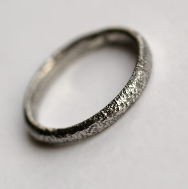 Rustic Oval Wedding band: This ring is made with oval shaped wire textured with reticulation technique. It is done with many rounds of high heat treatment resulting in melting of silver surface only.