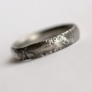 Rustic Oval Men's Wedding band: This ring is made with oval shaped wire textured with reticulation technique. It is done with many rounds of high heat treatment resulting in melting of silver surface only.
