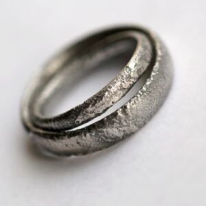 Rustic Oval Wedding Bands Set: These ring are made with oval shaped wire textured with reticulation technique. It is done with many rounds of high heat treatment resulting in melting of silver surface only.