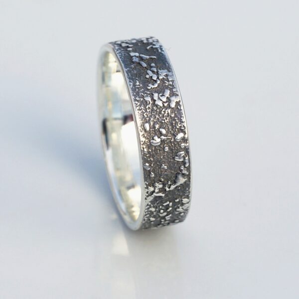 Silver Chaos - Oxidized Finish: Sterling silver wedding band with unique rustic texture. The texture is done by layering and fusing silver dust and micro pieces onto the heat treated surface of the ring.