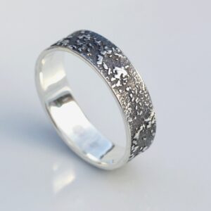 Silver Chaos - Oxidized Finish: Sterling silver wedding band with unique rustic texture. The texture is done by layering and fusing silver dust and micro pieces onto the heat treated surface of the ring.