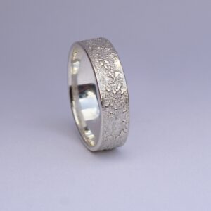 Silver Chaos - Shiny Finish: Sterling silver wedding band with unique rustic texture. The texture is done by layering and fusing silver dust and micro pieces onto the heat treated surface of the ring.
