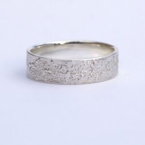 Silver Chaos - Shiny Finish: Sterling silver wedding band with unique rustic texture. The texture is done by layering and fusing silver dust and micro pieces onto the heat treated surface of the ring.