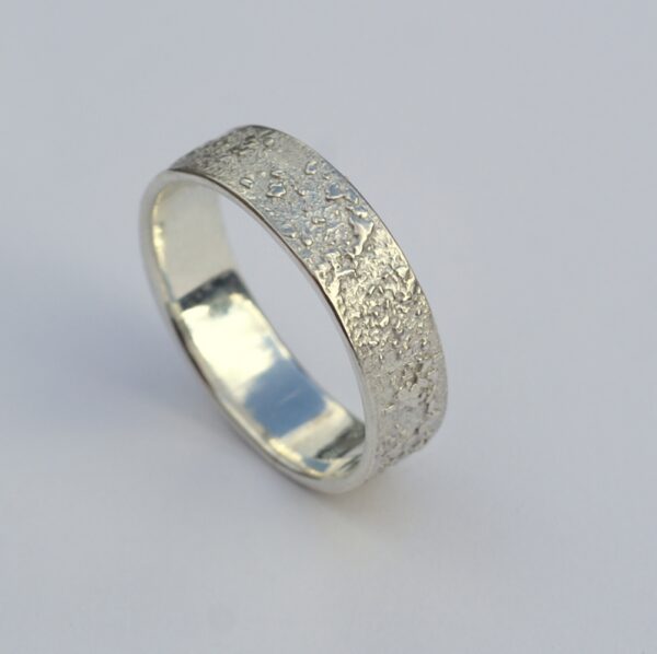 Silver Chaos - Shiny Finish: Sterling silver wedding band with unique rustic texture. The texture is done by layering and fusing silver dust and micro pieces onto the heat treated surface of the ring.