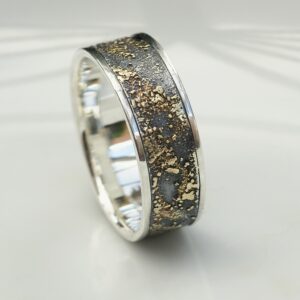 Gold Chaos with Silver Edges: The ring is made of sterling silver, slightly textured with reticulation and oxidized. Gold spots are solid 18kt gold. It is random mix of gold dust, microgranules and solder fused to silver surface. The edge is solid 18k gold.