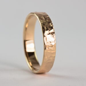 Rock Texture 9k Yellow Gold Ring: Simple hammered wedding band made of 9k yellow gold. The texture is made with my customized hammer so it is absolutely unique and it is not possible to make the same ring without that hammer.