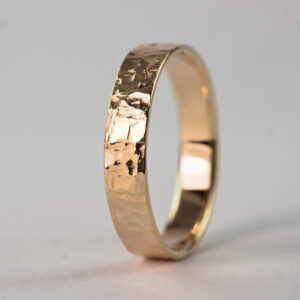 Rock Texture 9k Yellow Gold Ring: Simple hammered wedding band made of 9k yellow gold. The texture is made with my customized hammer so it is absolutely unique and it is not possible to make the same ring without that hammer.