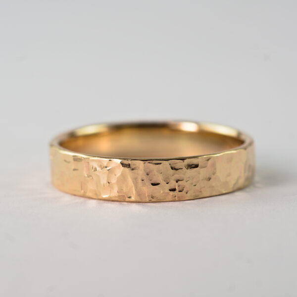 Rock Texture 9k Yellow Gold Ring: Simple hammered wedding band made of 9k yellow gold. The texture is made with my customized hammer so it is absolutely unique and it is not possible to make the same ring without that hammer.