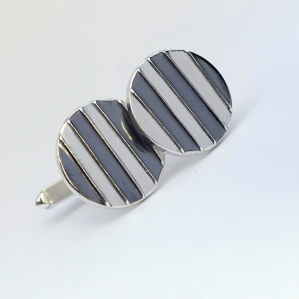 Striped Cufflinks: The stripes are oxidized and lightly polished to shiny black finish, the rest of the cufflinks is highly polished