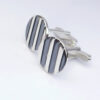 Striped Cufflinks: The stripes are oxidized and lightly polished to shiny black finish, the rest of the cufflinks is highly polished