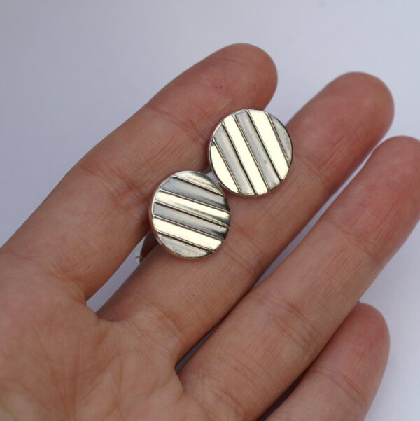 Striped Cufflinks: The stripes are oxidized and lightly polished to shiny black finish, the rest of the cufflinks is highly polished