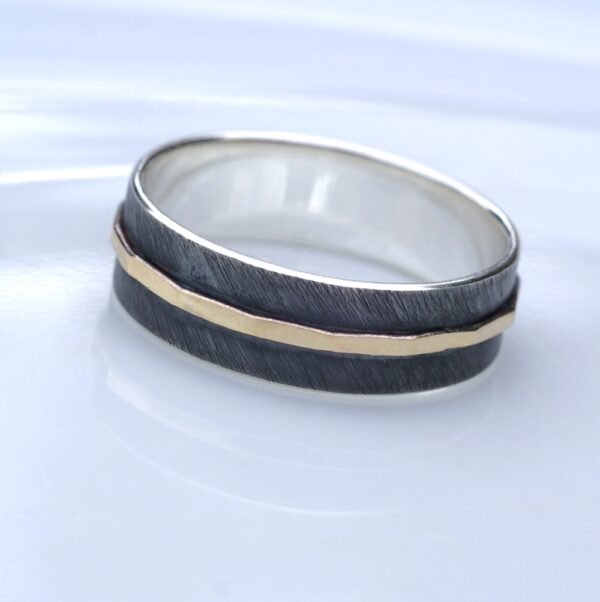 Textured - 6 mm Yellow Gold: The main part of the ring is made of sterling silver, textured, oxidized and slightly polished. Central yellow gold part is hammered and polished. Inside of the ring is also polished for contrast.