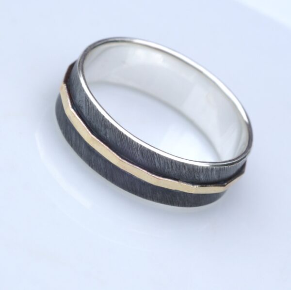 Textured - 6 mm Yellow Gold: The main part of the ring is made of sterling silver, textured, oxidized and slightly polished. Central yellow gold part is hammered and polished. Inside of the ring is also polished for contrast.