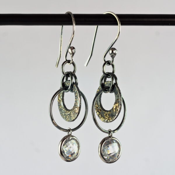 Oxidized sterling silver and 18k yellow gold cubic zirconia earrings.