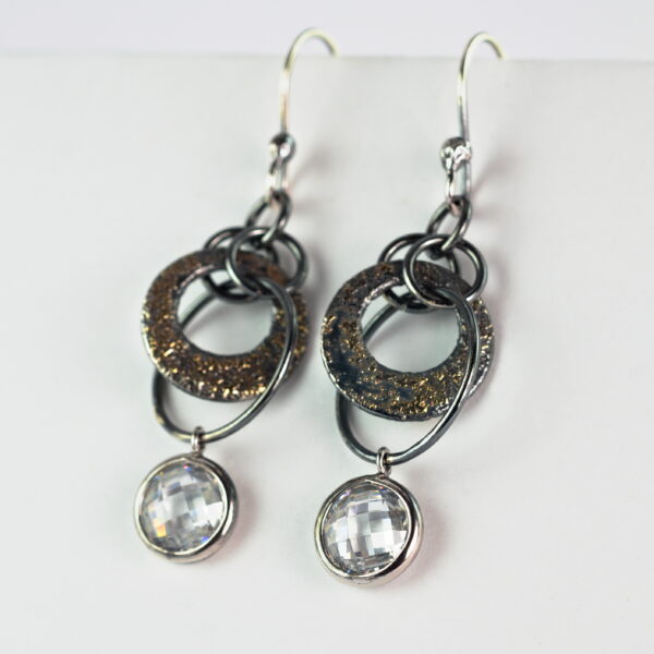 Oxidized sterling silver and 18k yellow gold cubic zirconia earrings.